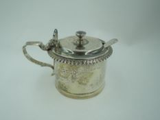 A Victorian silver mustard pot of plain cylindrical form having gadrooned rim and scallop shell