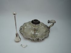 A Georgian silver chamber stick (missing sconce) having facetted saucer with shaped gadrooned rim