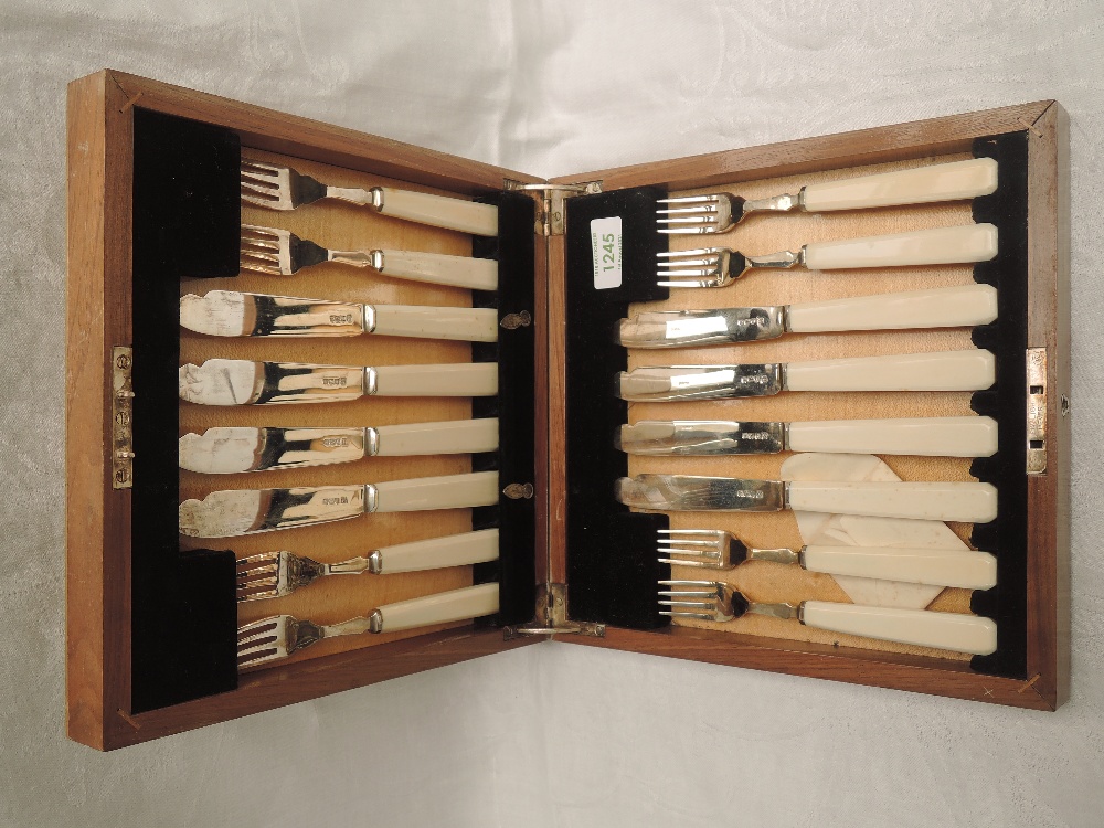 A 1930's cased eight place set of silver fish knives and forks having ivory handles, Sheffield 1937,