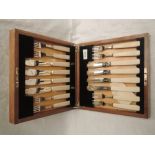 A 1930's cased eight place set of silver fish knives and forks having ivory handles, Sheffield 1937,