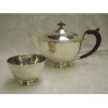 A silver tea pot and sugar bowl of plain form having fruit wood handle and knop, London 1937,