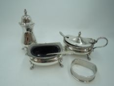 A silver three piece cruet set of traditional form having gadrooned rim and paw feet, Birmingham