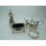 A silver three piece cruet set of traditional form having gadrooned rim and paw feet, Birmingham