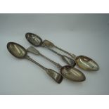 Four Victorian silver table spoons of fiddle back form having reeded decoration to rims and engraved