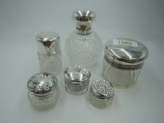 A cut glass spherical scent bottle having silver lid monogrammed G and glass stopper, London 1911, a