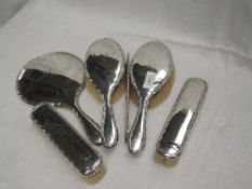 A silver six piece dressing table set of plain form having decorative edges and bearing monogram