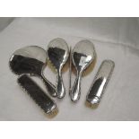 A silver six piece dressing table set of plain form having decorative edges and bearing monogram