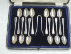 A cased set of twelve silver teaspoons with matching sugar nips having moulded decoration, Sheffield