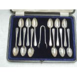 A cased set of twelve silver teaspoons with matching sugar nips having moulded decoration, Sheffield