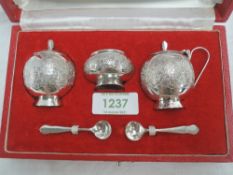 A cased Pakistani silver three piece cruet set of traditional Asian form, retailed by Kashmir Silver