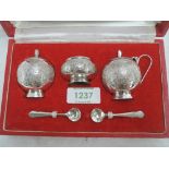 A cased Pakistani silver three piece cruet set of traditional Asian form, retailed by Kashmir Silver