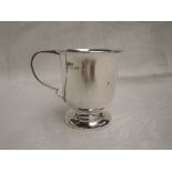 A small silver christening mug of plain form on a circular pedestal foot, Birmingham 1966, A T