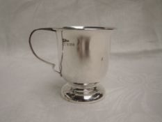 A small silver christening mug of plain form on a circular pedestal foot, Birmingham 1966, A T