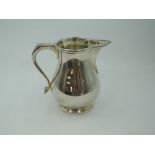 A silver cream jug of plain baluster form having thumb rest handle, London 1978, Edward Barnard &