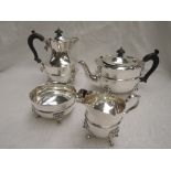 A 1920's silver four piece tea set of plain form having reided waists, lion mask paw feet and shaped