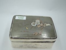 A Chinese silver box having black laquered wood lining, floral engravings to sides and yellow/rose