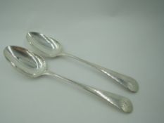 A pair of Georgian silver table spoons of old English form bearing monogram to terminals, London