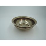 A middle Eastern white metal bowl stamped 900AG having central decorative panel to base, approx 70g