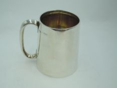 An Edwardian silver christening tankard of plain form (no inscription) having moulded loop handle,