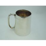 An Edwardian silver christening tankard of plain form (no inscription) having moulded loop handle,