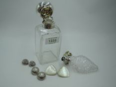 A Victorian glass bottle of rectangular form having glass stopper and silver hinged lid,