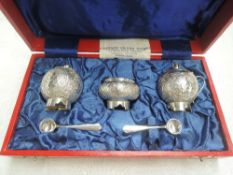 A cased Pakistani silver three piece cruet set of traditional Asian form, retailed by Kashmir Silver