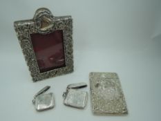 A small Victorian silver overlaid photograph frame having scroll and floral decoration and red