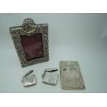 A small Victorian silver overlaid photograph frame having scroll and floral decoration and red