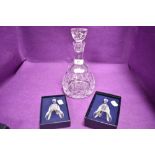 Two Caithness Christmas bells having etched designs with box and a glass wine decanter