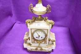 An antique French styled mantle clock having marble case with ormolu decals