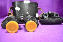 A pair of 8x21 binoculars and Tecnar Swift 8 x 30 binoculars