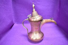 An antique coffee or chocolate pot having copper body with brass fitments bearing Arabic style mark
