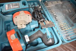 A battery powered Makita drill with accessories