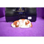 A ceramic paper weight by Royal Crown Derby of a Puppy Dog having Gold stopper and box