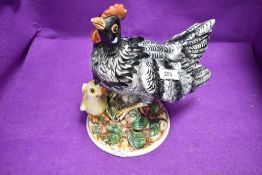 A ceramic study of a hen and chicken by Capodimonte