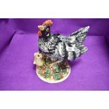 A ceramic study of a hen and chicken by Capodimonte