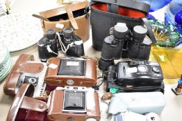 A selection of binoculars and photographic cameras including Swallow 8x40 and Agfa Isolette