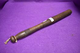 A wooden police or similar truncheon
