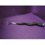 An antique toasting fork having African animal horn handle grip