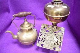 An antique brass cast fire trivet or kettle stand having French coat of arms also kettle and lamp