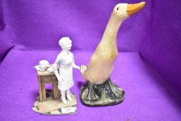 A hand decorated chalk ware runner duck and a nurse figure study by H.Little