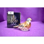 A ceramic Royal Crown Derby paper weight or figure of a Linnet having gold stopper and box