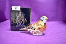 A ceramic Royal Crown Derby paper weight or figure of a Linnet having gold stopper and box