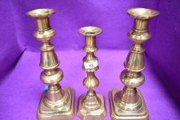 A pair of large Victorian cast brass candle sticks and similar