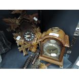 Two clocks including wall mounted German style cuckoo clock and Tempus Fugit mantle clock