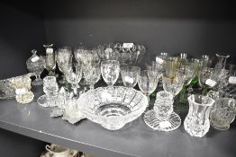 A selection of clear cut crystal glass wares including colour stem and etched spirit glasses