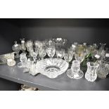 A selection of clear cut crystal glass wares including colour stem and etched spirit glasses