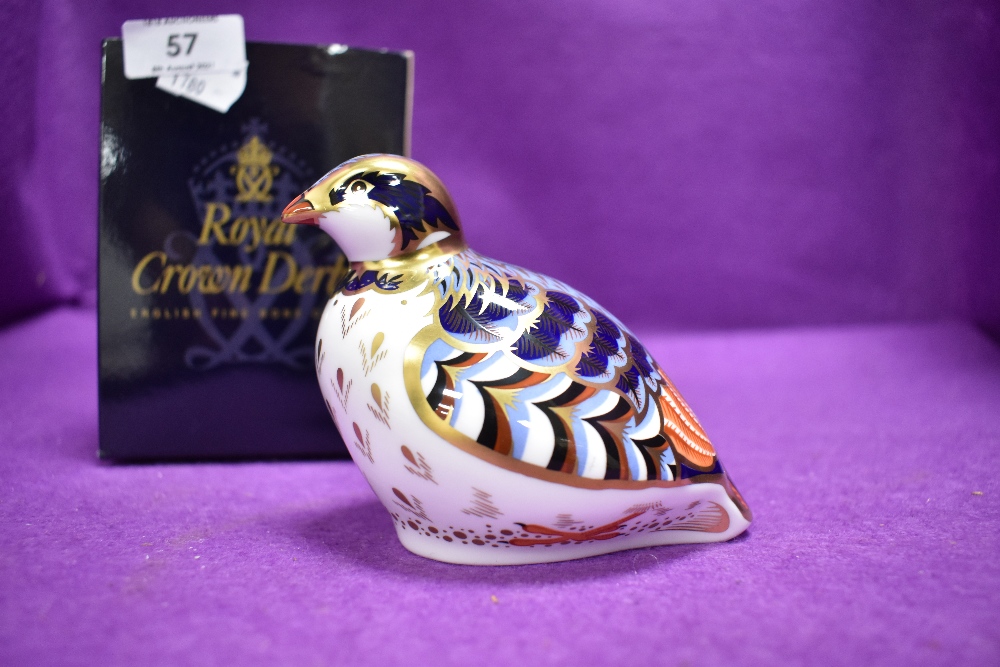 A ceramic Royal Crown Derby paper weight or figure of a Red Leg Partridge having gold stopper and