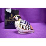 A ceramic Royal Crown Derby paper weight or figure of a Red Leg Partridge having gold stopper and