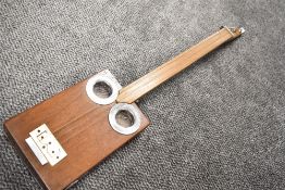 A cigar box style guitar, three string